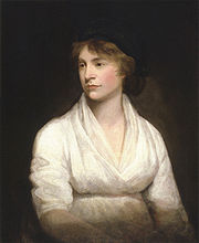  Portrait d'une femme en début de grossesse, regardant vers la gauche, et vêtue d'une robe blanche