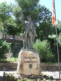Statue en bronze de Pere Joan Barcelo ("Catalunya Al Carrasclet") à Capçanes. Carasquet est vêtu de son uniforme de trabucaire, coiffé de la barretine (le couvre-chef traditionnel catalan) et tient à la main gauche un tromblon.