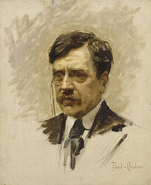 Portrait de trois quarts gauche de Paul Bourget, en costume et cravate, portant un monocle à l’œil droit.