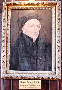 Un homme âgé en robe et manteau noirs et un chapeau, le portrait se trouve dans un cadre doré.