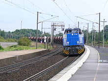 Un train de fret tracté par un couplage de locomotives diesel Veolia Transport s'apprête à traverser la gare