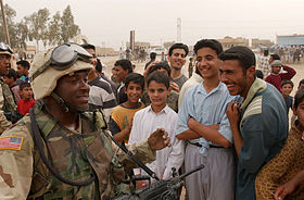 US Navy 030408-N-5362A-003 Iraqis share a laugh with a U.S. Army soldier during an effort to distribute food and water to Iraqi citizens in need.jpg